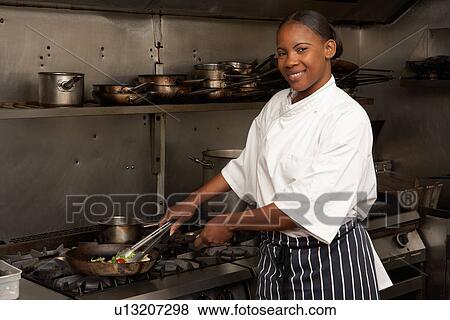 Female Chef Preparing Meal On Cooker In Restaurant Kitchen View Large Photo Image Stock Photo - Female Chef Preparing Meal On Cooker In Restaurant Kitchen. Fotosearch