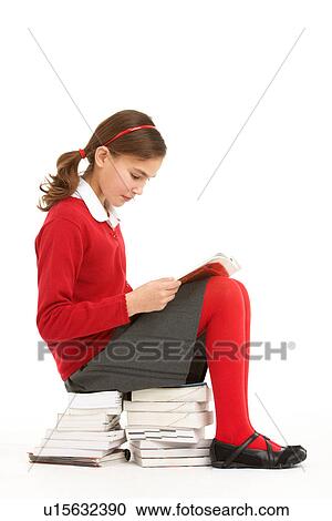 Female Student In Uniform Sitting On Pile Of Books Reading View Large Photo Image Stock Image - Female Student In Uniform Sitting On Pile Of Books Reading. Fotosearch