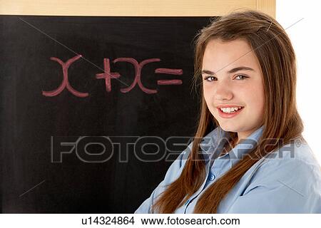 Picture - Female Student Standing Next To Blackboard. Fotosearch
