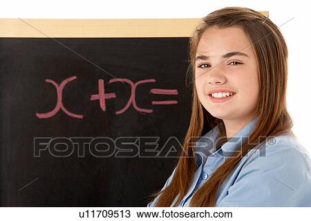 Stock Image - Female Student Standing Next To Blackboard. Fotosearch
