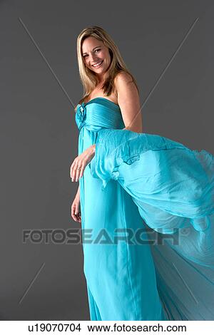 Full Length Studio Shot Of Young Woman In Blue Evening Dress View Large Photo Image Picture - Full Length Studio Shot Of Young Woman In Blue Evening Dress. Fotosearch