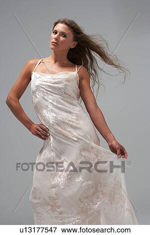 Full Length Studio Shot Of Young Woman In White Evening Dress View Large Photo Image Stock Photo - Full Length Studio Shot Of Young Woman In White Evening Dress. Fotosearch