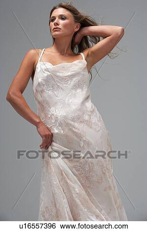 Full Length Studio Shot Of Young Woman In White Evening Dress View Large Photo Image Stock Photograph - Full Length Studio Shot Of Young Woman In White Evening Dress. Fotosearch