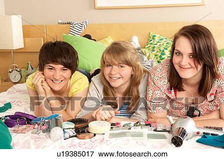 Stock Photo - Group Of Teenage Girls In Untidy Bedroom. Fotosearch