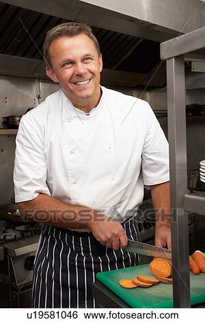 Stock Photograph - Male Chef Preparing Vegetables In Restaurant Kitchen. Fotosearch