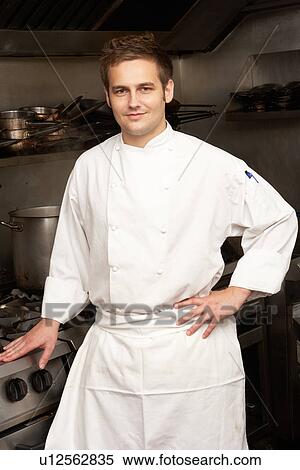 Male Chef Standing Next To Cooker In Restaurant Kitchen View Large Photo Image Stock Photography - Male Chef Standing Next To Cooker In Restaurant Kitchen. Fotosearch
