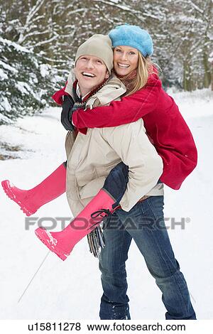 Man Giving Woman Piggyback In Snowy Woodland View Large Photo Image Stock Photo - Man Giving Woman Piggyback In Snowy Woodland. Fotosearch