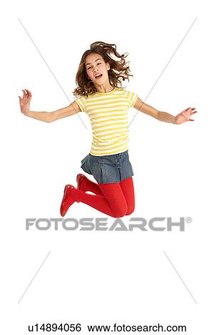 Stock Photograph - Mid Air Studio Shot Of Young Girl Jumping In Air. Fotosearch