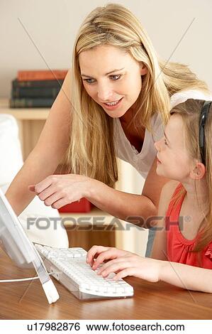 Stock Photograph - Mother And Daughter At Home Using Computer. Fotosearch