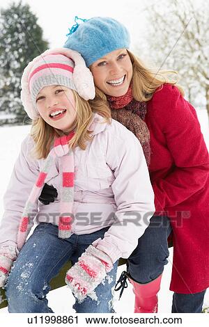 Mother And Daughter Standing Outside In Snowy Landscape View Large Photo Image Stock Image - Mother And Daughter Standing Outside In Snowy Landscape. Fotosearch