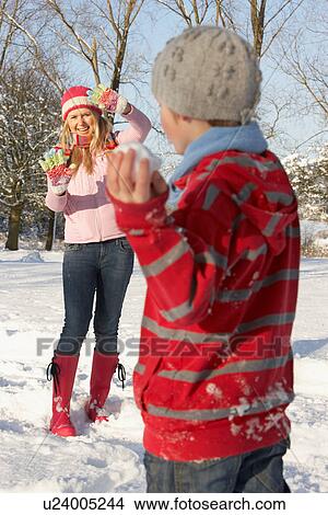 Mother And Son Having Snowball Fight In Snowy Landscape View Large Photo Image Picture - Mother And Son Having Snowball Fight In Snowy Landscape. Fotosearch