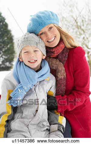 Stock Photograph - Mother And Son Standing Outside In Snowy Landscape. Fotosearch