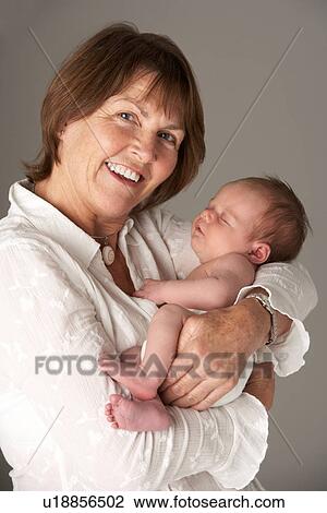 Stock Image - Mother Holding Newborn Baby. Fotosearch