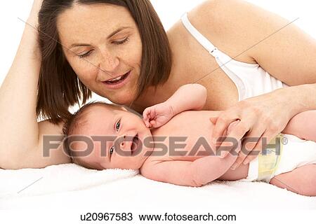 Stock Image - Mother Holding Newborn Baby. Fotosearch