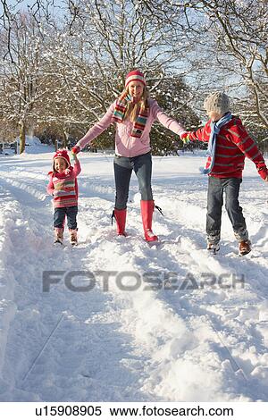 Stock Photography - Mother Walking With Children Through Snowy Landscape. Fotosearch