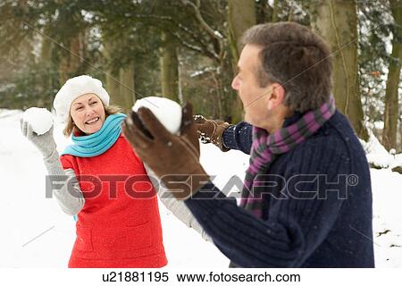 Senior Couple Having Snowball Fight In Snowy Woodland View Large Photo Image Stock Photography - Senior Couple Having Snowball Fight In Snowy Woodland. Fotosearch