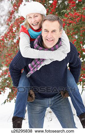 Stock Photo - Senior Couple Outside In Snowy Landscape. Fotosearch
