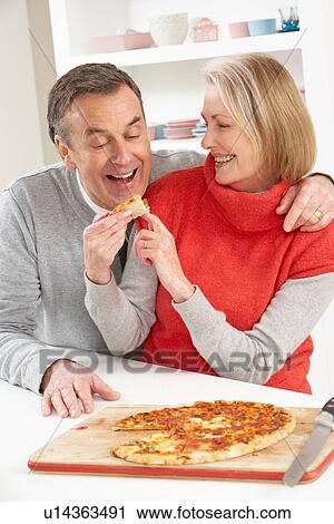Senior Couple Sharing Takeaway Pizza In Kitchen View Large Photo Image Stock Image - Senior Couple Sharing Takeaway Pizza In Kitchen. Fotosearch