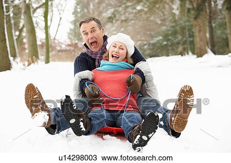 Senior Couple Sledging Through Snowy Woodland View Large Photo Image Stock Image - Senior Couple Sledging Through Snowy Woodland. Fotosearch