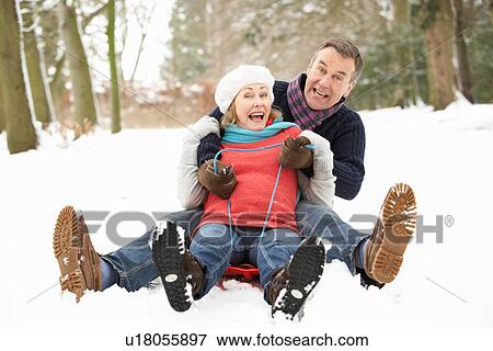 Senior Couple Sledging Through Snowy Woodland View Large Photo Image Stock Photo - Senior Couple Sledging Through Snowy Woodland. Fotosearch
