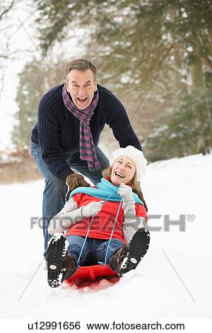 Senior Couple Sledging Through Snowy Woodland View Large Photo Image Stock Photograph - Senior Couple Sledging Through Snowy Woodland. Fotosearch