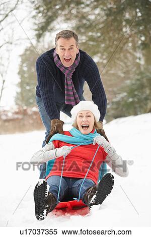 Senior Couple Sledging Through Snowy Woodland View Large Photo Image Stock Photography - Senior Couple Sledging Through Snowy Woodland. Fotosearch