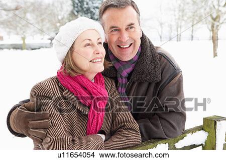 Picture - Senior Couple Standing Outside In Snowy Landscape. Fotosearch