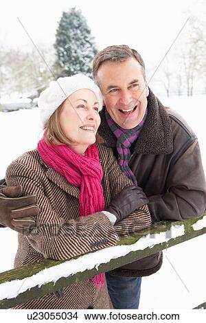 Picture - Senior Couple Standing Outside In Snowy Landscape. Fotosearch