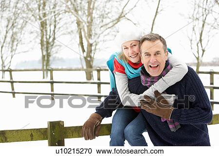 Senior Couple Standing Outside In Snowy Landscape View Large Photo Image Stock Image - Senior Couple Standing Outside In Snowy Landscape. Fotosearch