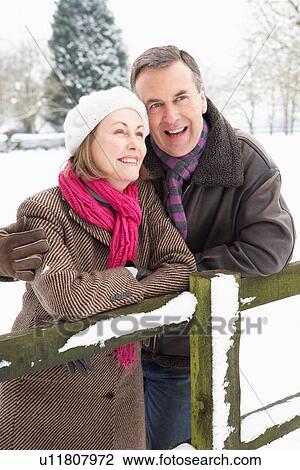 Senior Couple Standing Outside In Snowy Landscape View Large Photo Image Stock Image - Senior Couple Standing Outside In Snowy Landscape. Fotosearch