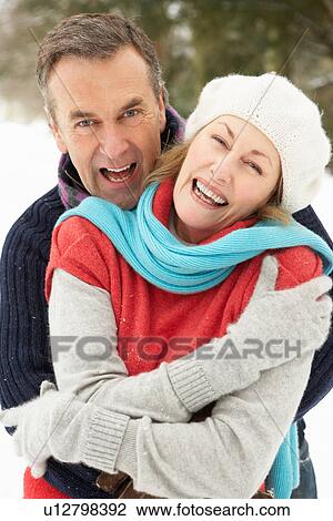 Senior Couple Standing Outside In Snowy Landscape View Large Photo Image Stock Image - Senior Couple Standing Outside In Snowy Landscape. Fotosearch