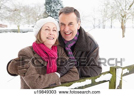Senior Couple Standing Outside In Snowy Landscape View Large Photo Image Stock Image - Senior Couple Standing Outside In Snowy Landscape. Fotosearch