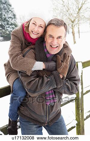 Senior Couple Standing Outside In Snowy Landscape View Large Photo Image Stock Photo - Senior Couple Standing Outside In Snowy Landscape. Fotosearch