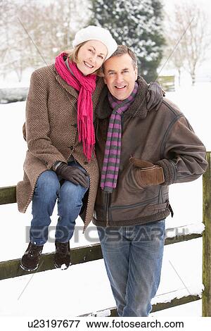 Senior Couple Standing Outside In Snowy Landscape View Large Photo Image Stock Photo - Senior Couple Standing Outside In Snowy Landscape. Fotosearch