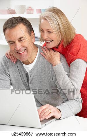 Stock Photo - Senior Couple Using Laptop At Home. Fotosearch