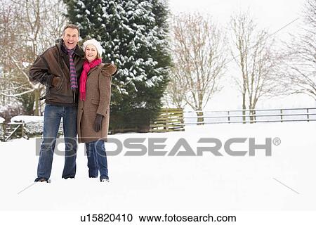 Senior Couple Walking In Snowy Landscape View Large Photo Image Stock Image - Senior Couple Walking In Snowy Landscape. Fotosearch