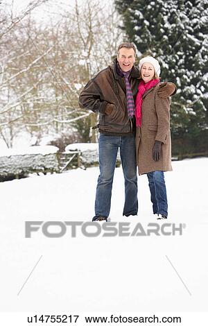 Senior Couple Walking In Snowy Landscape View Large Photo Image Stock Photo - Senior Couple Walking In Snowy Landscape. Fotosearch