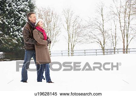Senior Couple Walking In Snowy Landscape View Large Photo Image Stock Photography - Senior Couple Walking In Snowy Landscape. Fotosearch
