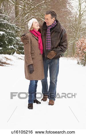 Senior Couple Walking Through Snowy Woodland View Large Photo Image Stock Photograph - Senior Couple Walking Through Snowy Woodland. Fotosearch