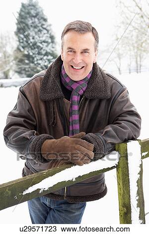 Senior Man Standing Outside In Snowy Landscape View Large Photo Image Stock Image - Senior Man Standing Outside In Snowy Landscape. Fotosearch