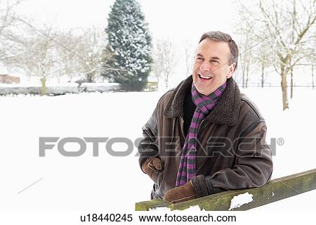 Senior Man Standing Outside In Snowy Landscape View Large Photo Image Stock Photography - Senior Man Standing Outside In Snowy Landscape. Fotosearch