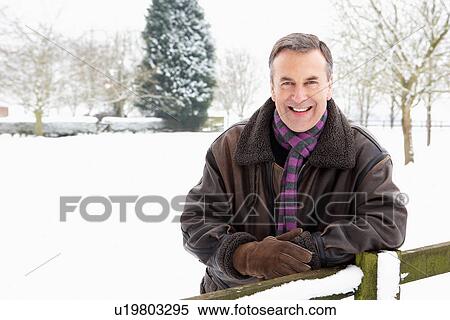Senior Man Standing Outside In Snowy Landscape View Large Photo Image Stock Photography - Senior Man Standing Outside In Snowy Landscape. Fotosearch
