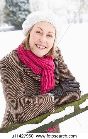 Senior Woman Standing Outside In Snowy Landscape View Large Photo Image Stock Image - Senior Woman Standing Outside In Snowy Landscape. Fotosearch
