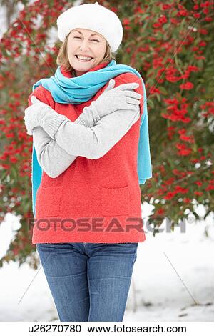 Senior Woman Standing Outside In Snowy Landscape View Large Photo Image Stock Image - Senior Woman Standing Outside In Snowy Landscape. Fotosearch