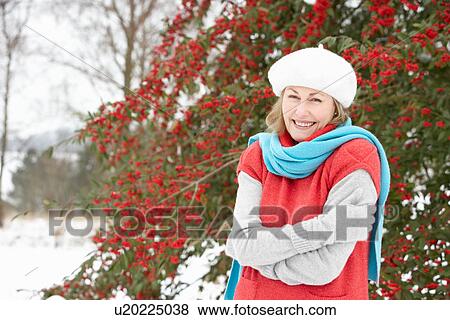 Senior Woman Standing Outside In Snowy Landscape View Large Photo Image Stock Photo - Senior Woman Standing Outside In Snowy Landscape. Fotosearch