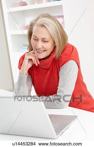 Senior Woman Using Laptop At Home View Large Photo Image Picture - Senior Woman Using Laptop At Home. Fotosearch