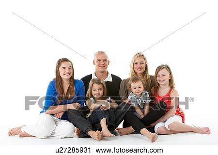 Stock Image - Shot Of Family Group Sitting In Studio. Fotosearch