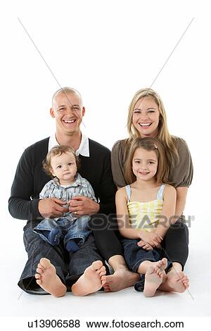 Stock Photo - Shot Of Family Group Sitting In Studio. Fotosearch