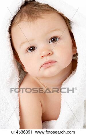 Stock Image - Studio Portrait Of Baby Boy Wrapped In Towel. Fotosearch