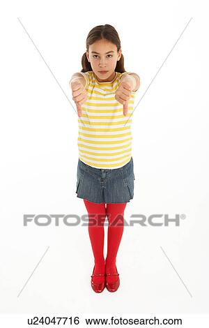 Studio Portrait Of Defiant Young Girl Giving Thumbs Down Gesture View Large Photo Image Stock Photograph - Studio Portrait Of Defiant Young Girl Giving Thumbs Down Gesture. Fotosearch
